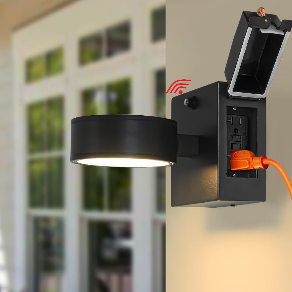 Black outdoor wall light fixture with open cover revealing wiring against a blurred background