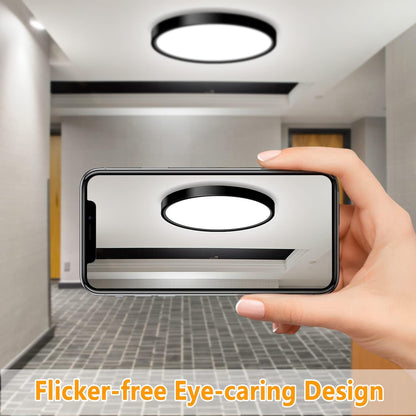 Hand holding a smartphone displaying an image of a ceiling light fixture with 'Flicker-free Eye-caring Design' text.