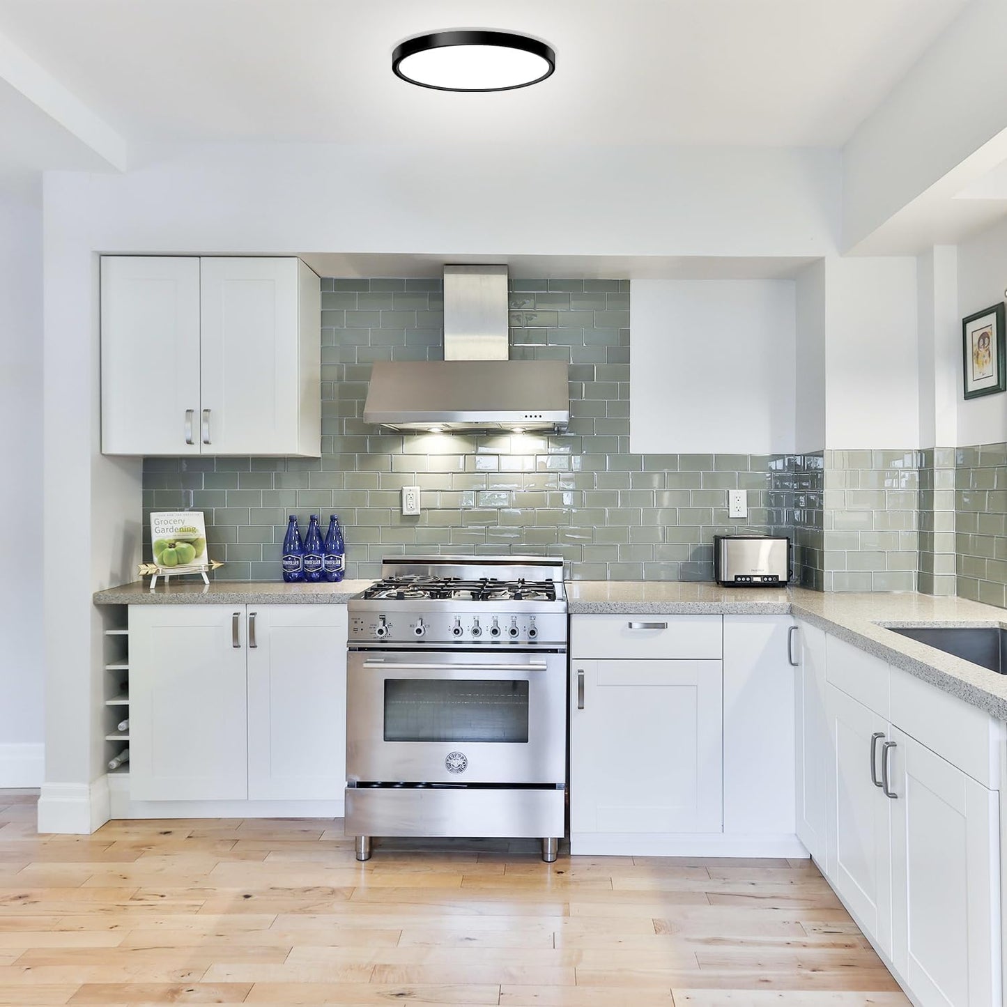 Modern kitchen with stainless steel oven and green tiled backsplash