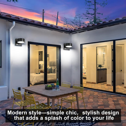 Modern outdoor patio with glass doors leading to a bedroom and bathroom, featuring a wooden table and chairs.