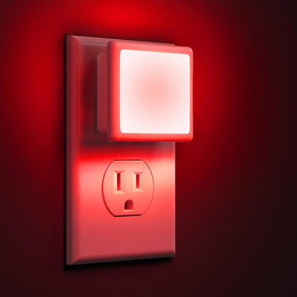 Red night light attached to a wall outlet on a red background