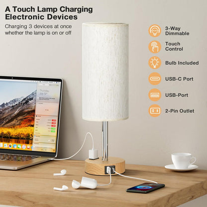 Table lamp with multiple charging ports on a desk next to a laptop, phone, and earbuds.