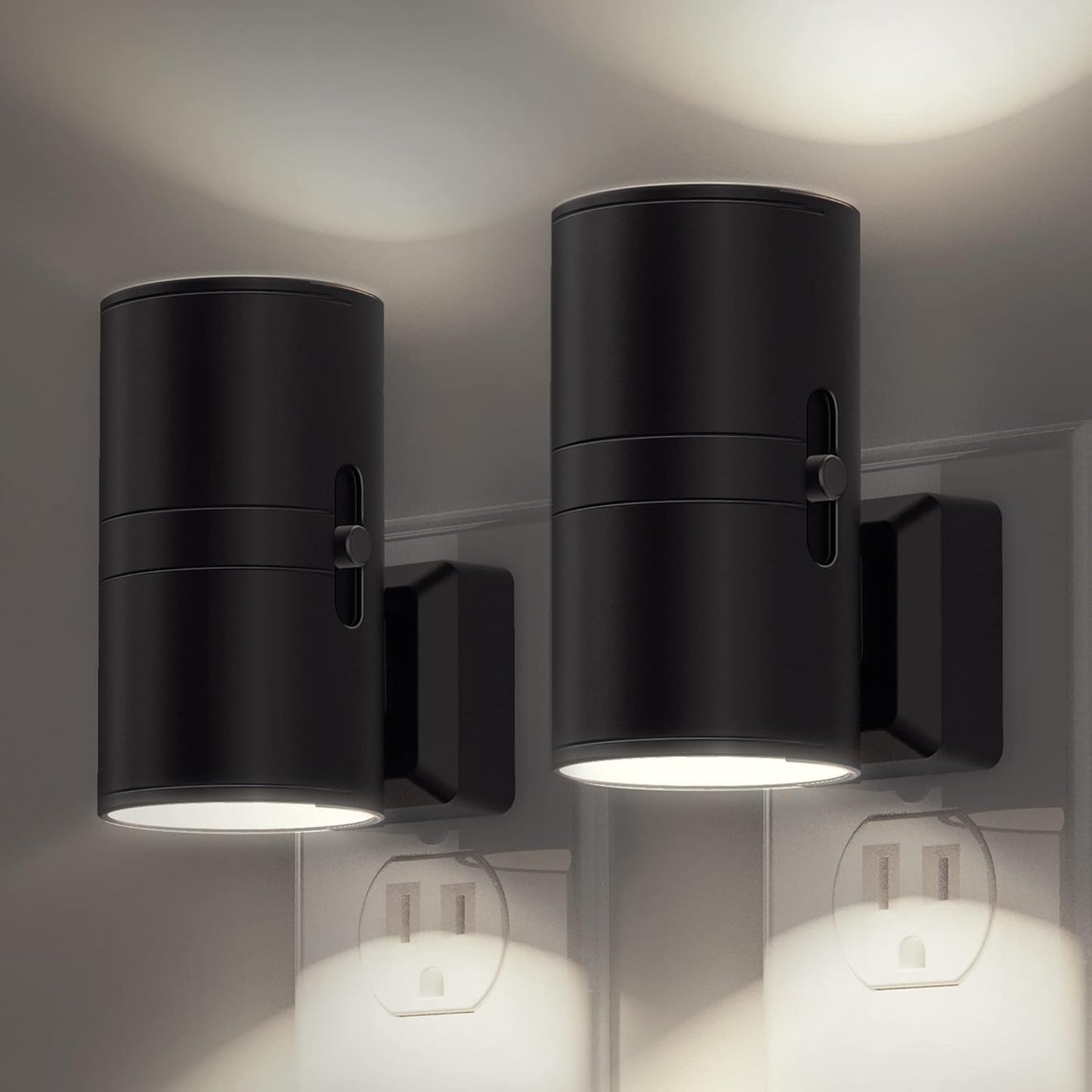 Two black cylindrical wall lights on a gray wall.