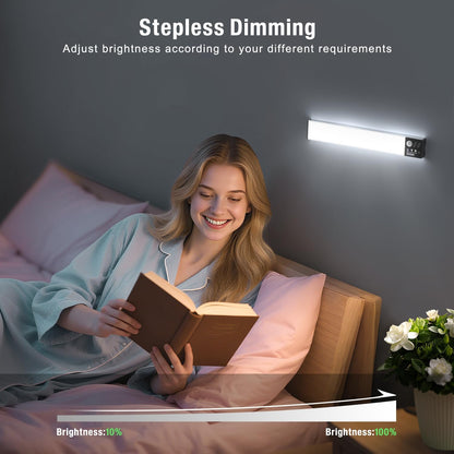 Woman reading a book in bed with stepless dimming light above her.